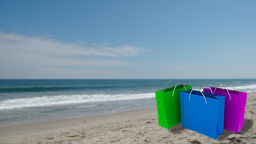 Colorful shopping bags on the beach