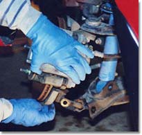 Pulling the hub away from the lower A-arm.